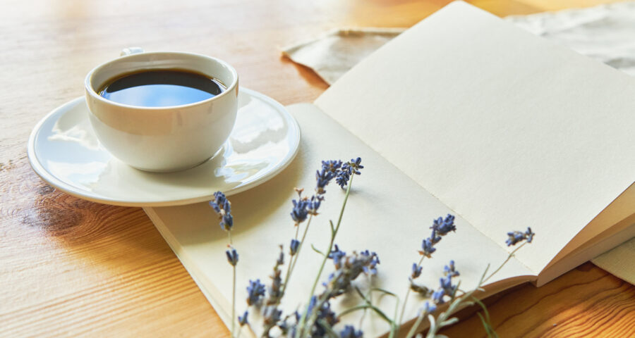 Coffee in a white cup on white linen fabric. Positive morning with coffee and lavenderщ